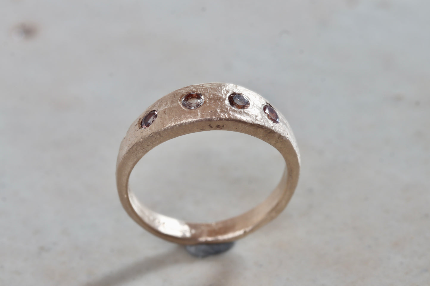 organic rustic ethical sustainable eco recycled sandcast gold eternity band wedding band paige devlin jewelry montana sapphire lavender peach brown