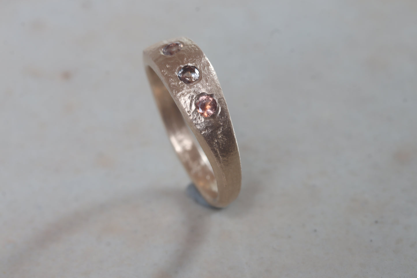 organic rustic ethical sustainable eco recycled sandcast gold eternity band wedding band paige devlin jewelry montana sapphire lavender peach brown