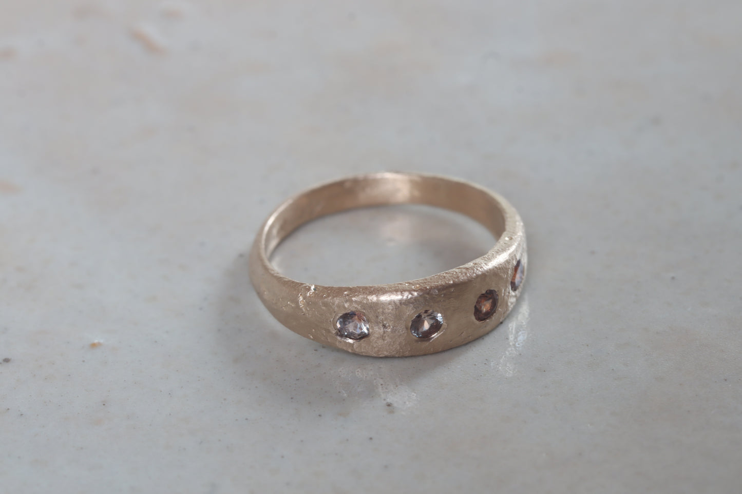 organic rustic ethical sustainable eco recycled sandcast gold eternity band wedding band paige devlin jewelry montana sapphire lavender peach brown