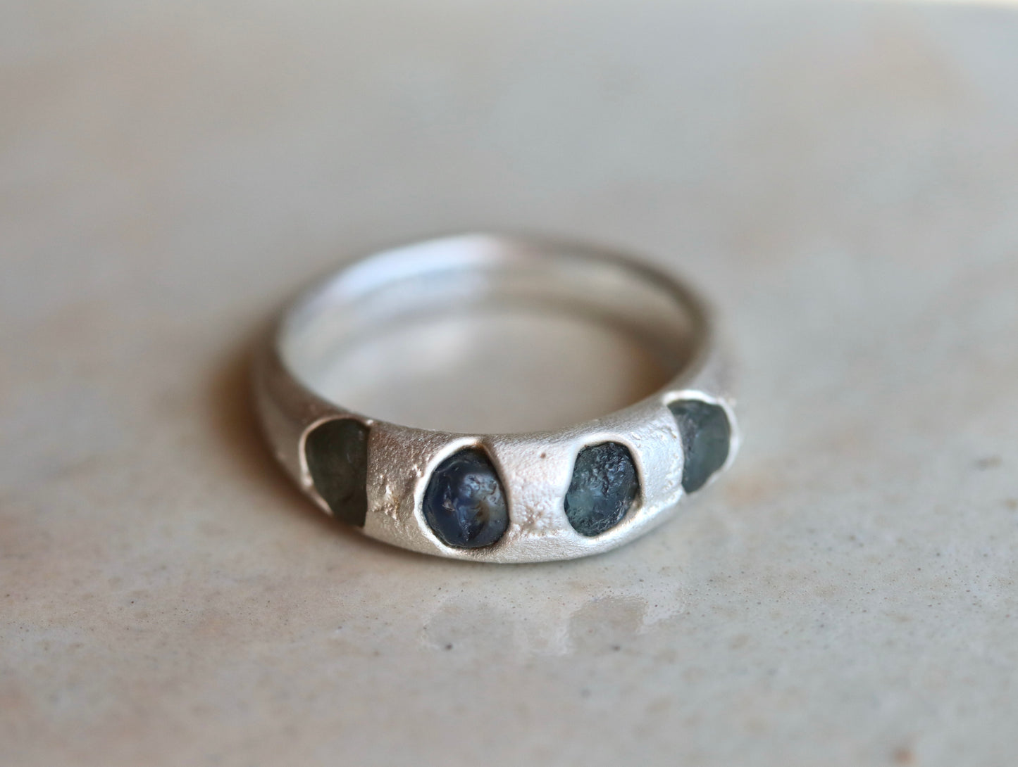 raw montana sapphire sandcast rough rustic earthy cast in place wedding thick silver band paige devlin jewelry