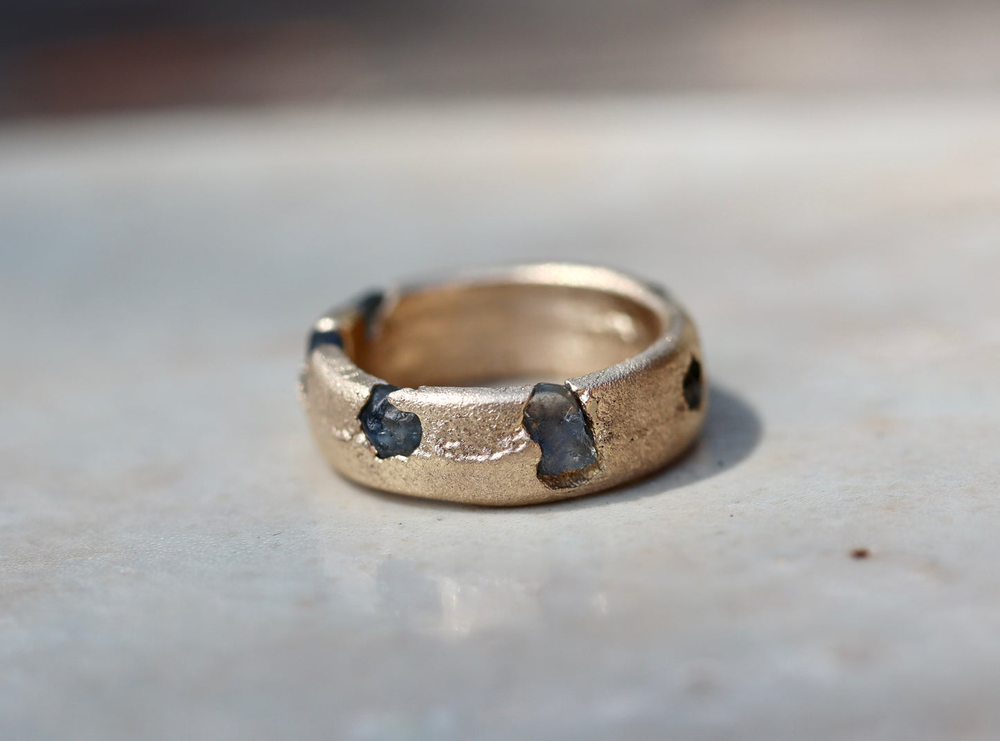 organic texture raw montana sapphire recycled gold sandcast ethical earthen paige devlin jewelry rustic rough mens wedding band