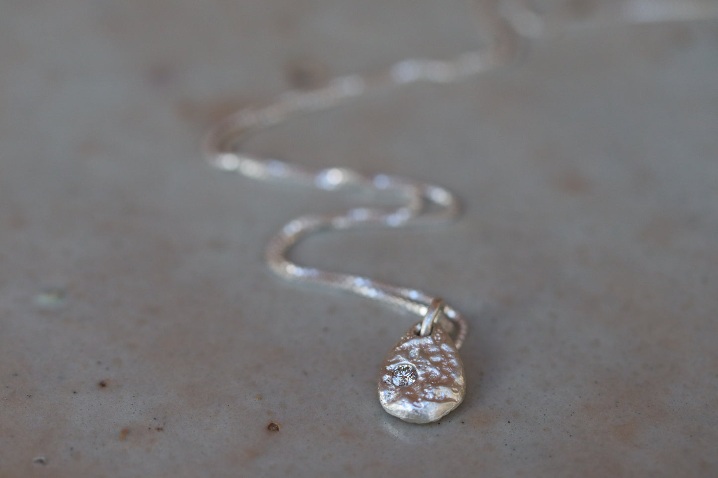 ethical diamond organic texture sandcast small petite necklace paige devlin jewelry minimal organic pendant silver