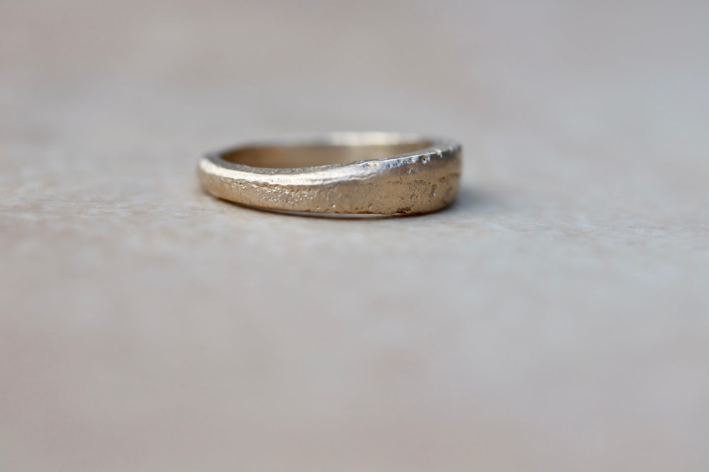 thin 14kt recycled gold organic minimal texture sandcast wedding band ethical paige devlin jewelry