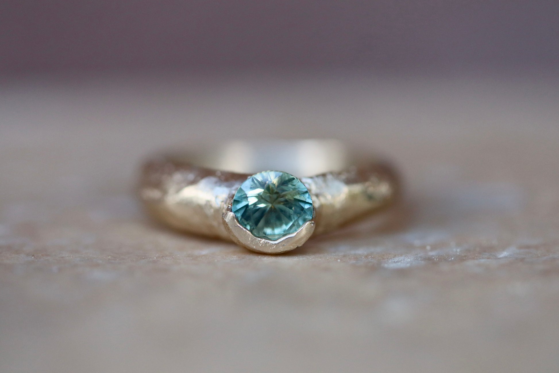 rustic organic ethical whimsical earthy ethereal montana sapphire green sandcast solitaire engagement ring paige devlin jewelry methow valley wedding jewelry